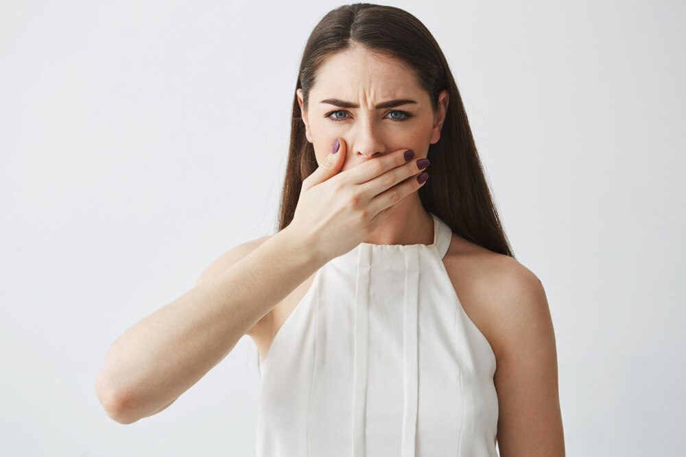 displeased young brunette girl covering mouth with hand white backround 176420 9898