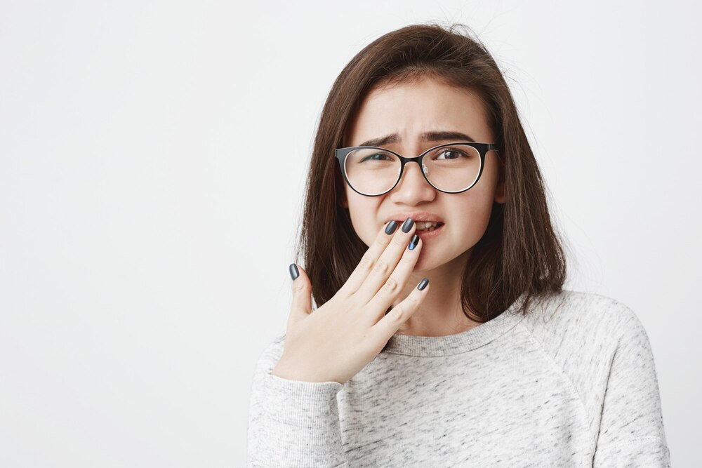 portrait young cute female glasses squinting covering her mouth with hand feeling pain sorry 176420 15322